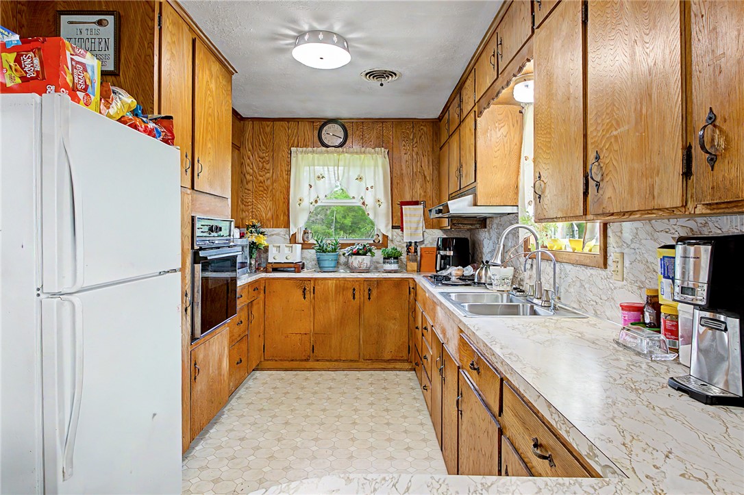 11576 Carter Lane Bryan, TX 77808 - Photo 15 of 50 a kitchen with stainless steel appliances granite countertop a sink a stove and a refrigerator