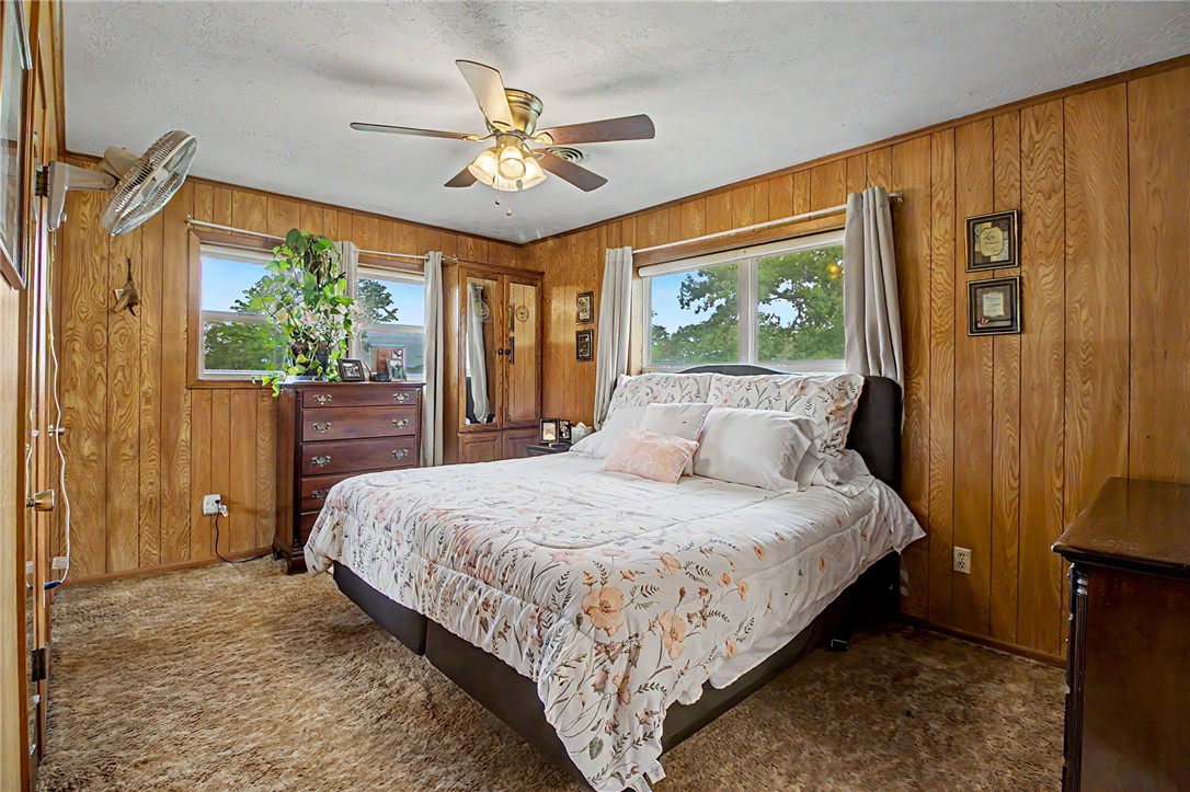 11576 Carter Lane Bryan, TX 77808 - Photo 27 of 50 a bedroom with a large bed and a chandelier