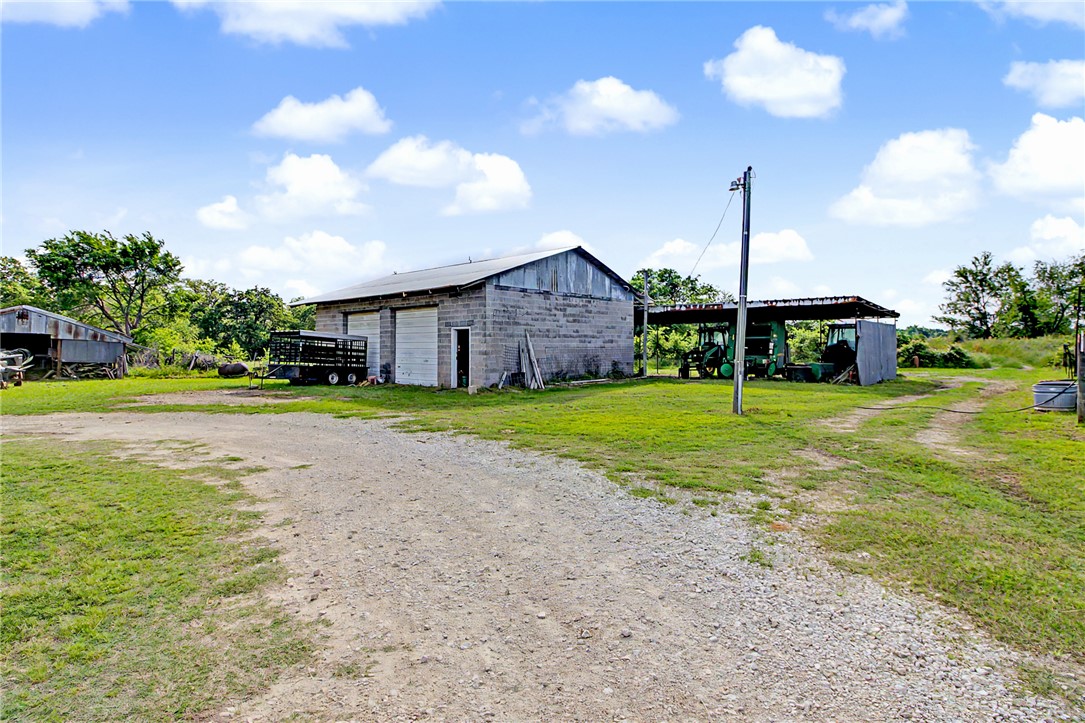 11576 Carter Lane Bryan, TX 77808 - Photo 32 of 50 a view of a house with a yard and large trees