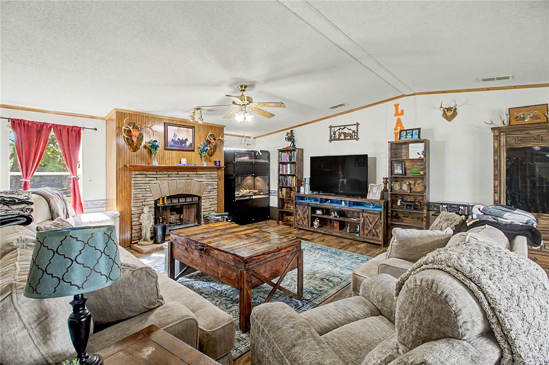 11576 Carter Lane Bryan, TX 77808 - Photo 42 of 50 a living room with furniture a flat screen tv and a fireplace