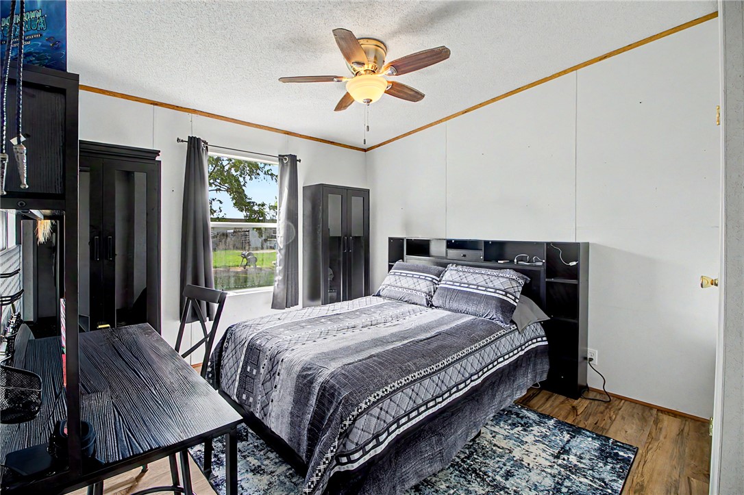 11576 Carter Lane Bryan, TX 77808 - Photo 49 of 50 a bedroom with bed and a chandelier