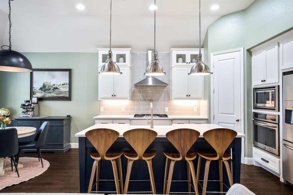 1501 Snowdrop Drive Prosper, TX 75078 - Photo 2 of 27 a kitchen with cabinets and chairs