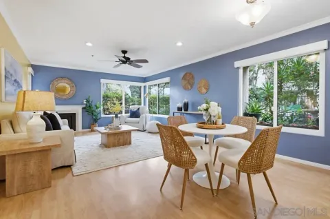 a living room with fireplace furniture and a large window