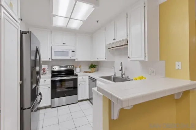 a kitchen with a sink cabinets and dining table