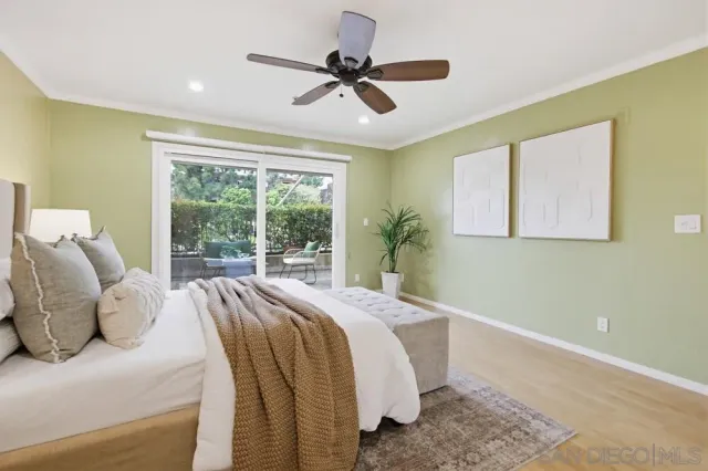 a spacious bedroom with a bed and wooden floor