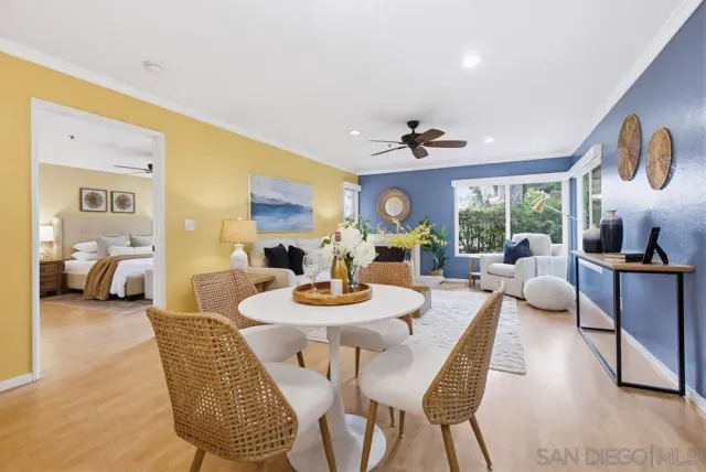 a view of a dining room with furniture a chandelier and wooden floor