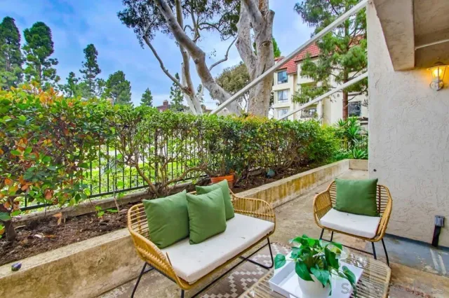 a balcony with outdoor seating and plants