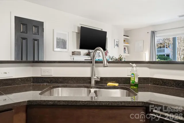 a kitchen with a sink and a mirror