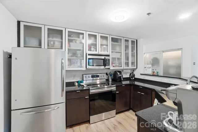 a kitchen with a refrigerator and a stove