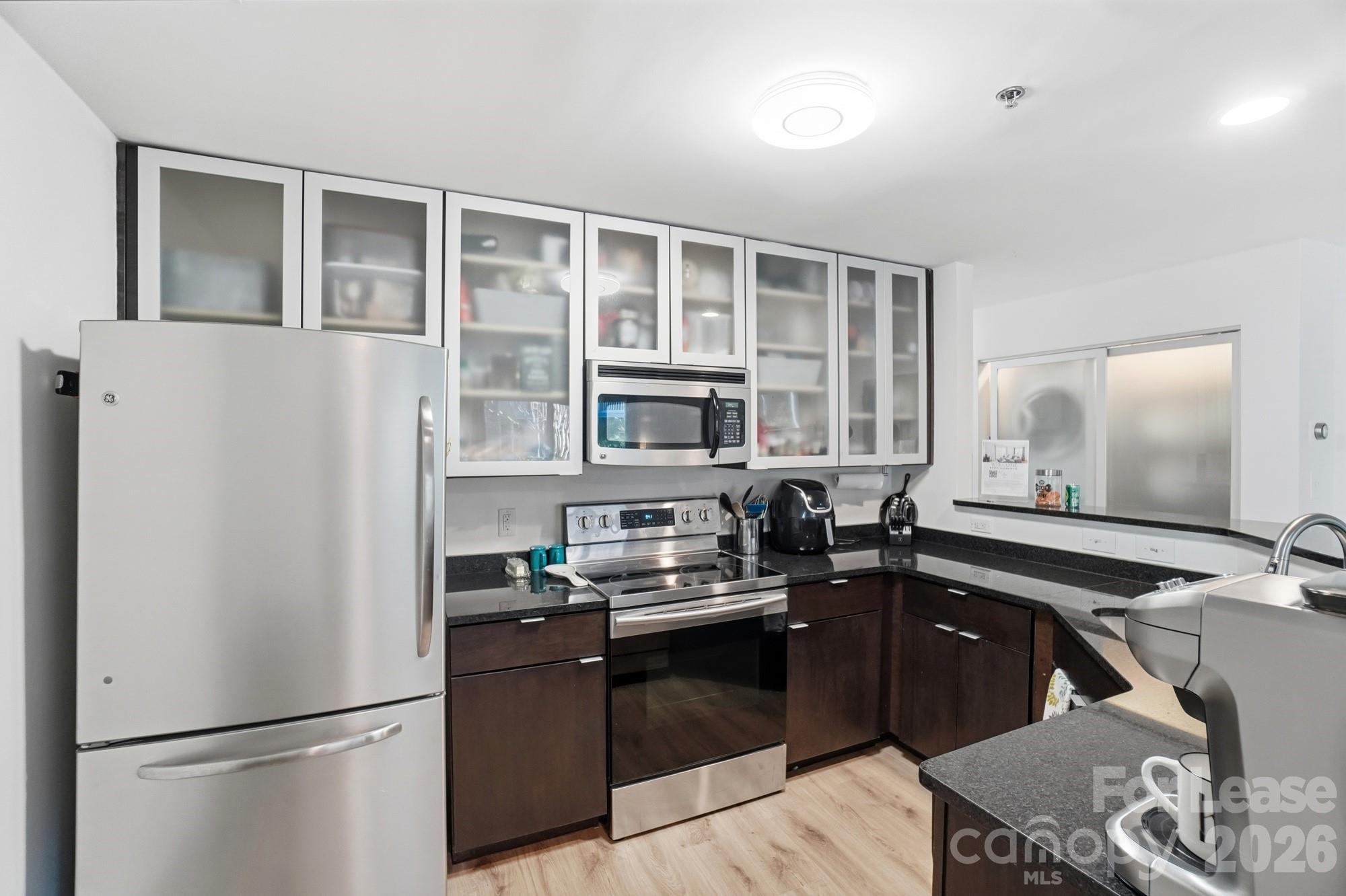 525 North Graham Street, Unit 2F Charlotte, NC 28202 - Photo 9 of 18 a kitchen with a refrigerator and a stove