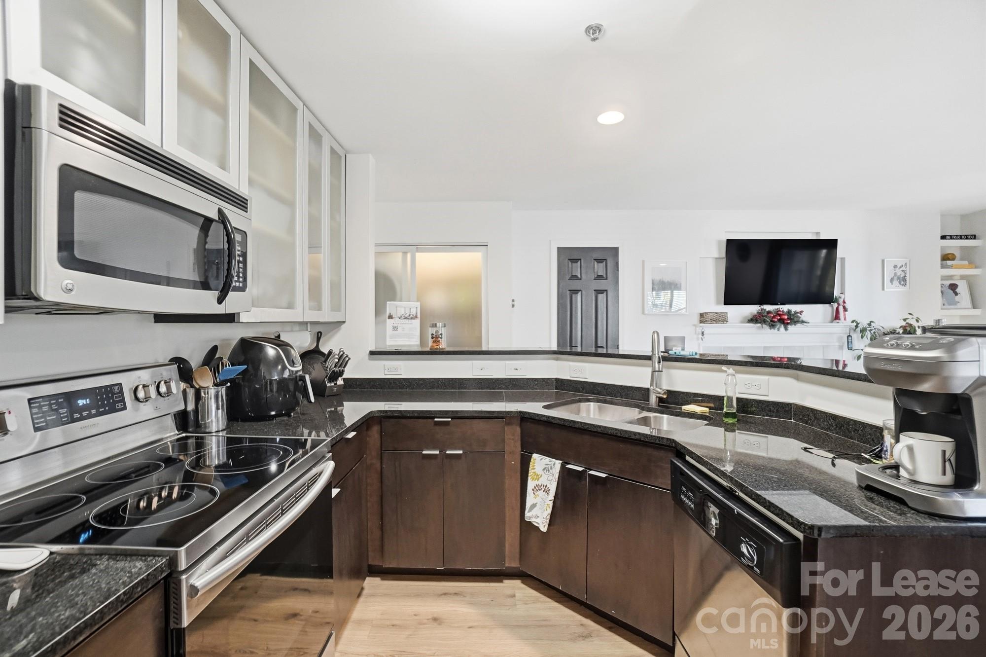 525 North Graham Street, Unit 2F Charlotte, NC 28202 - Photo 10 of 18 a kitchen with a sink appliances and cabinets