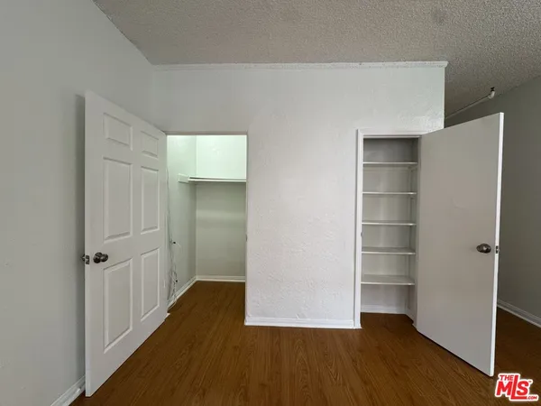 a view of a room with wooden floor and closet