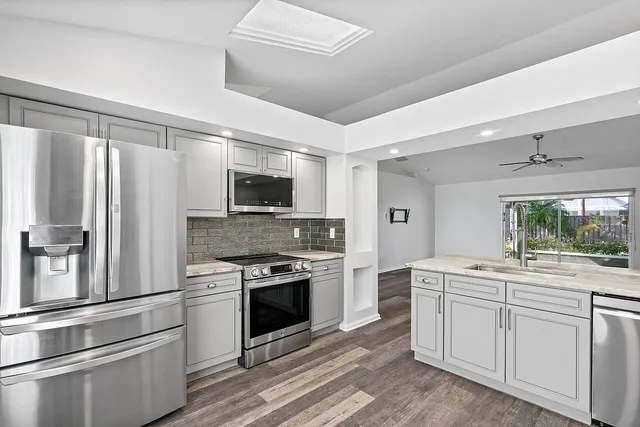 a kitchen with a sink stove and refrigerator