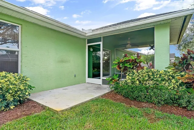 a front view of yellow house with garden