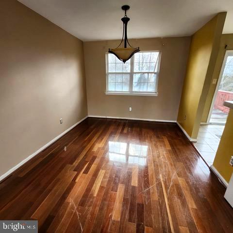 3 Morning Star Court Baltimore, MD 21206 - Photo 11 of 43 a view of empty room with wooden floor and windows