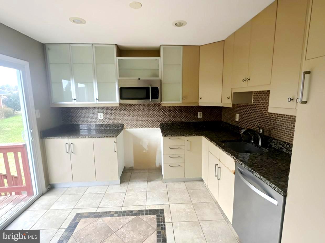 3 Morning Star Court Baltimore, MD 21206 - Photo 4 of 28 a kitchen with stainless steel appliances kitchen island granite countertop a sink and a stove