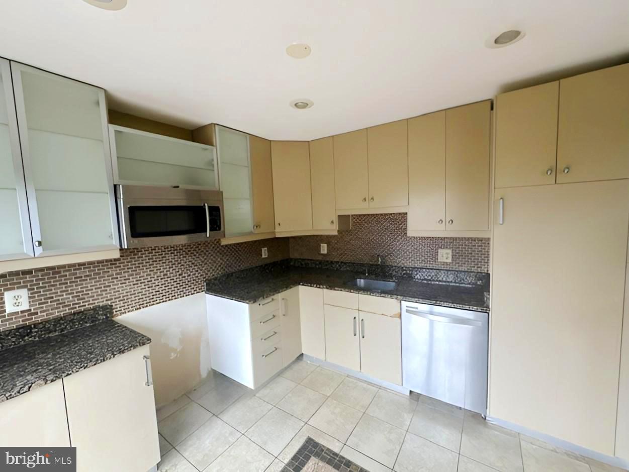 3 Morning Star Court Baltimore, MD 21206 - Photo 5 of 28 a kitchen with granite countertop a sink a stove and cabinets