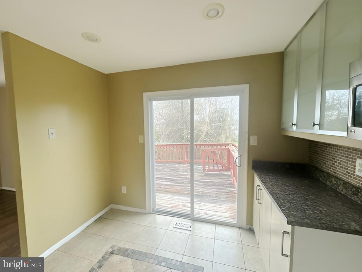 3 Morning Star Court Baltimore, MD 21206 - Photo 6 of 28 a view of an empty room with a fireplace and a window