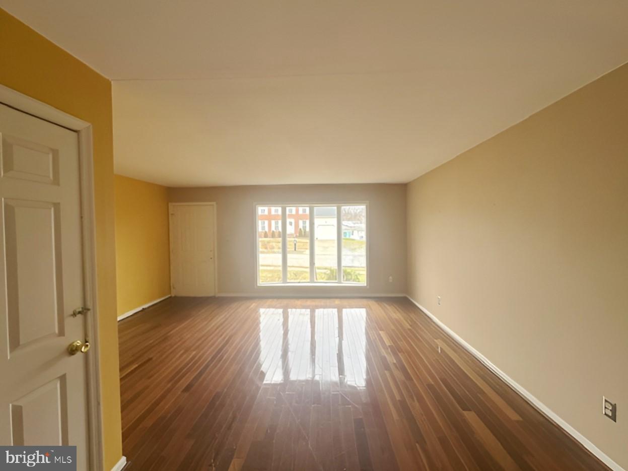 3 Morning Star Court Baltimore, MD 21206 - Photo 9 of 28 an empty room with wooden floor and windows