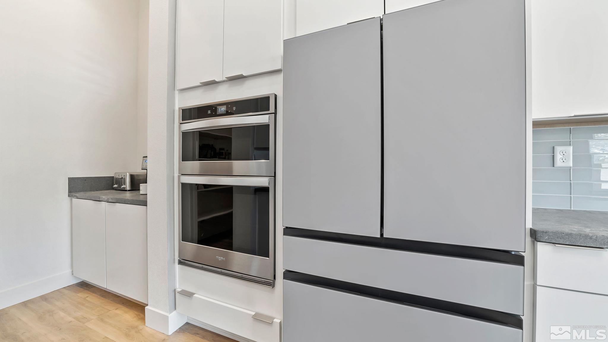 13550 Water Willow Street Reno, NV 89521 - Photo 11 of 37 a kitchen with cabinets and white appliances