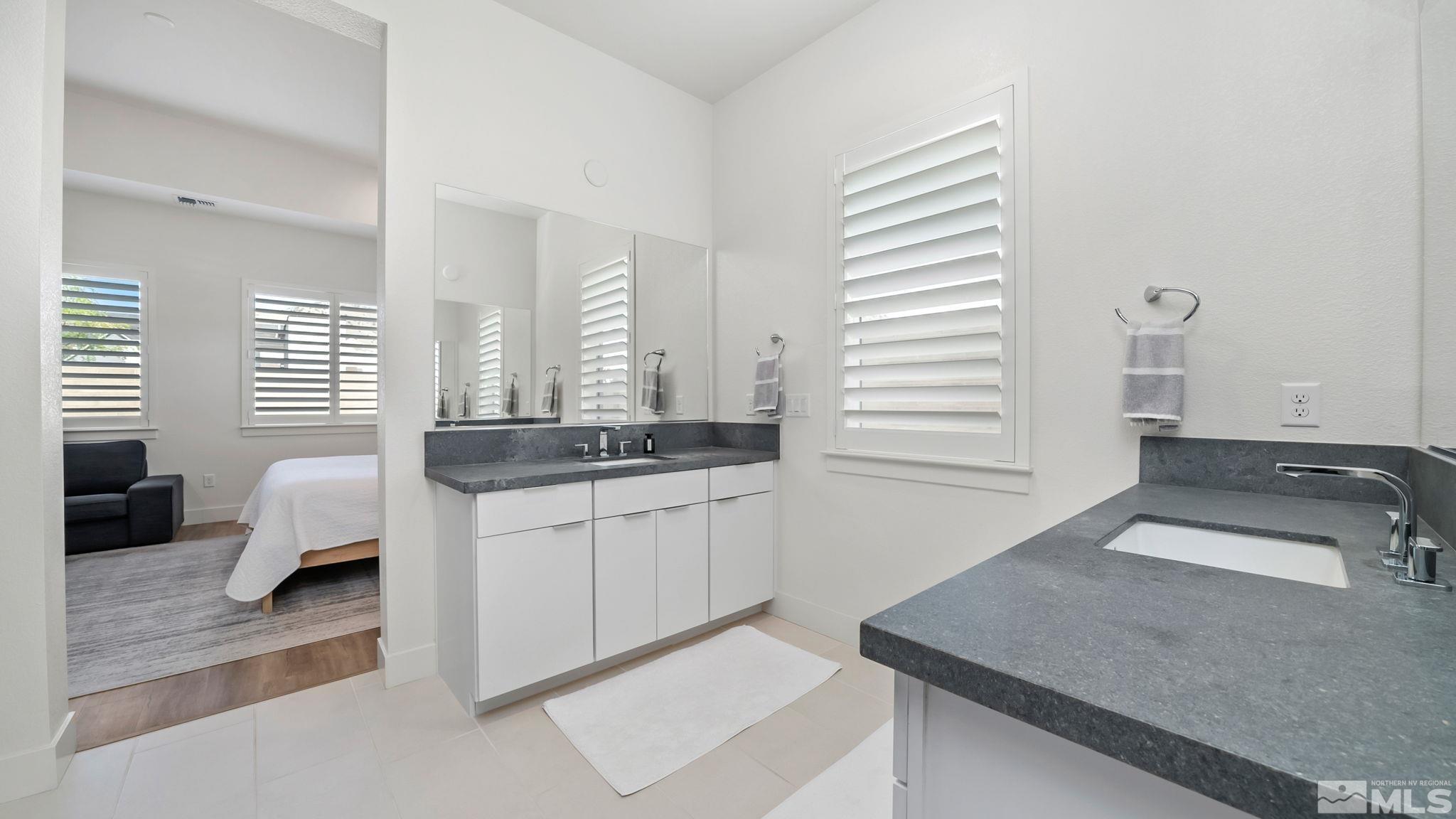 13550 Water Willow Street Reno, NV 89521 - Photo 22 of 37 a kitchen with granite countertop white cabinets and white appliances