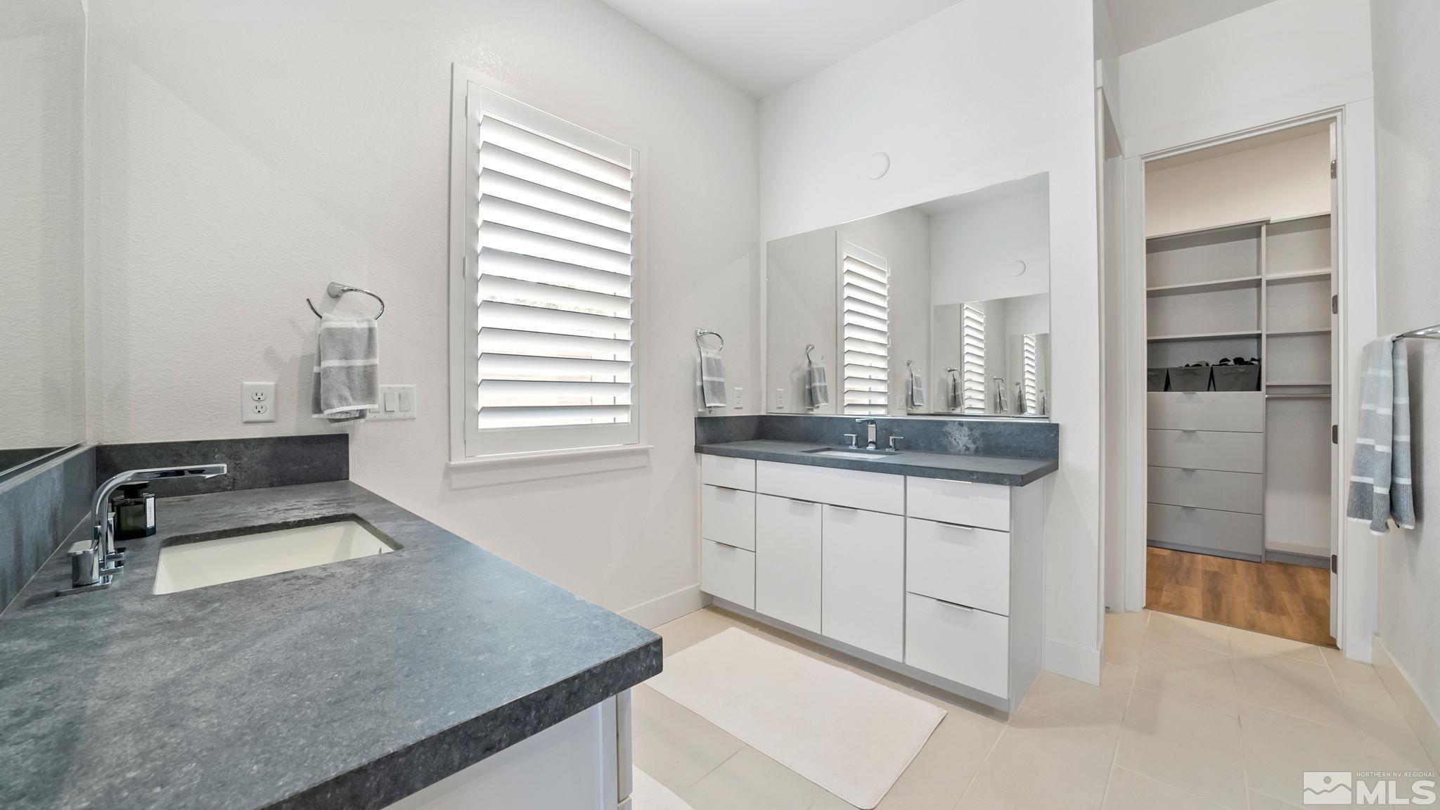 13550 Water Willow Street Reno, NV 89521 - Photo 23 of 37 a kitchen with granite countertop white cabinets and white appliances