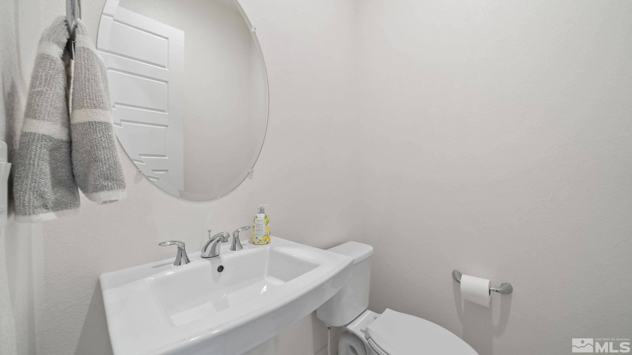 13550 Water Willow Street Reno, NV 89521 - Photo 30 of 37 a bathroom with a sink a toilet and mirror