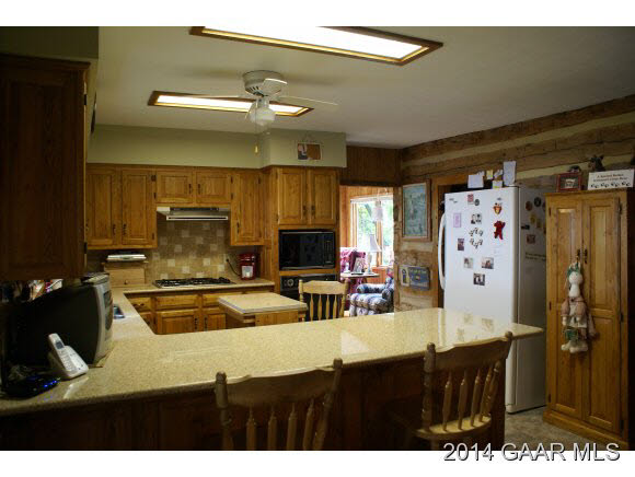 2679 Shutterlee Mill Road Staunton, VA 24401 - Photo 13 of 34 a kitchen with stainless steel appliances kitchen island granite countertop a refrigerator and a stove top oven