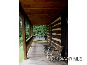 2679 Shutterlee Mill Road Staunton, VA 24401 - Photo 32 of 34 a view of a patio with table and chairs with wooden floor and fence