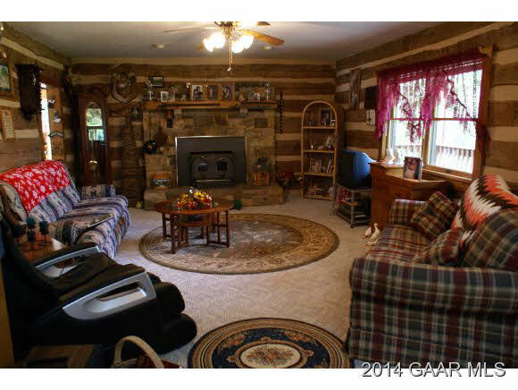 2679 Shutterlee Mill Road Staunton, VA 24401 - Photo 8 of 34 a living room with furniture a fireplace and a flat screen tv