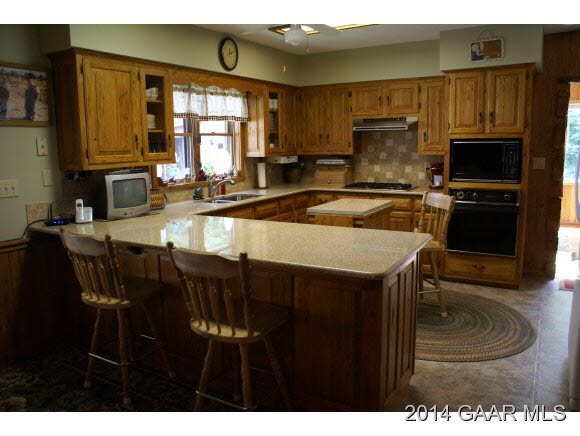 2679 Shutterlee Mill Road Staunton, VA 24401 - Photo 9 of 34 a kitchen with a table chairs microwave and cabinets