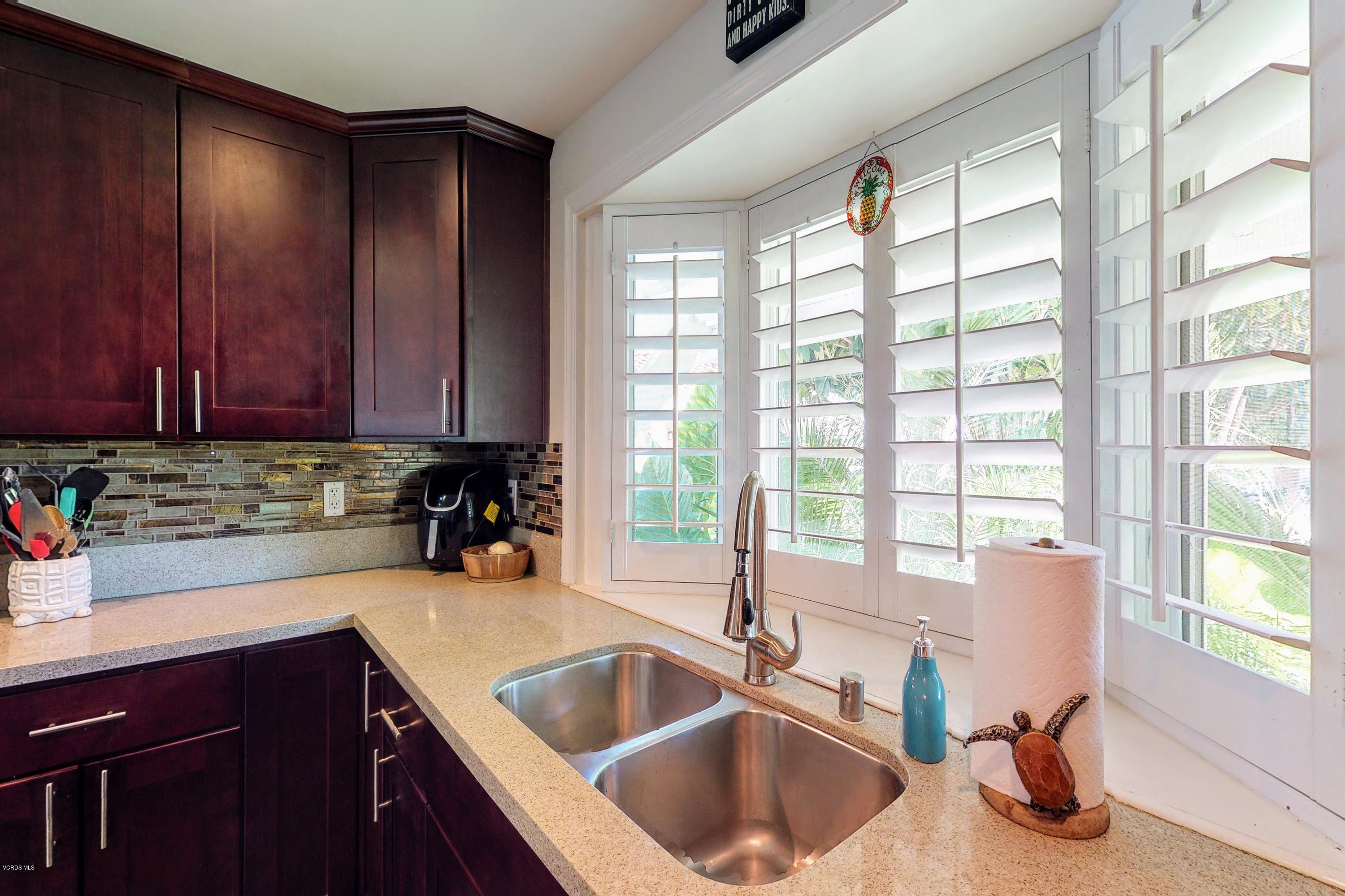 2298 Copley Street Simi Valley, CA 93063 - Photo 12 of 51 a kitchen with a sink a counter and cabinets