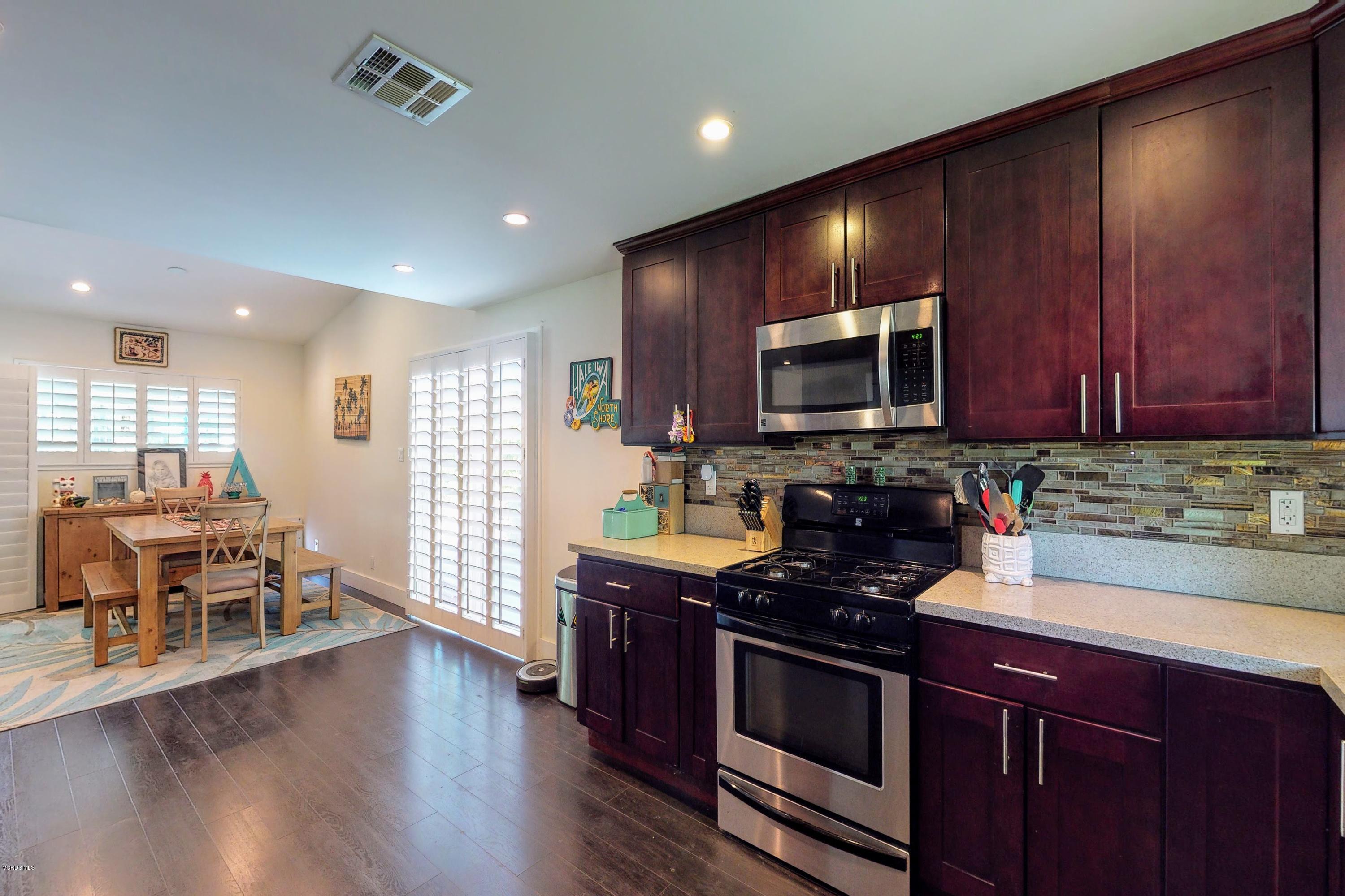 2298 Copley Street Simi Valley, CA 93063 - Photo 13 of 51 a kitchen with stainless steel appliances granite countertop wooden cabinets a stove top oven a sink and dishwasher
