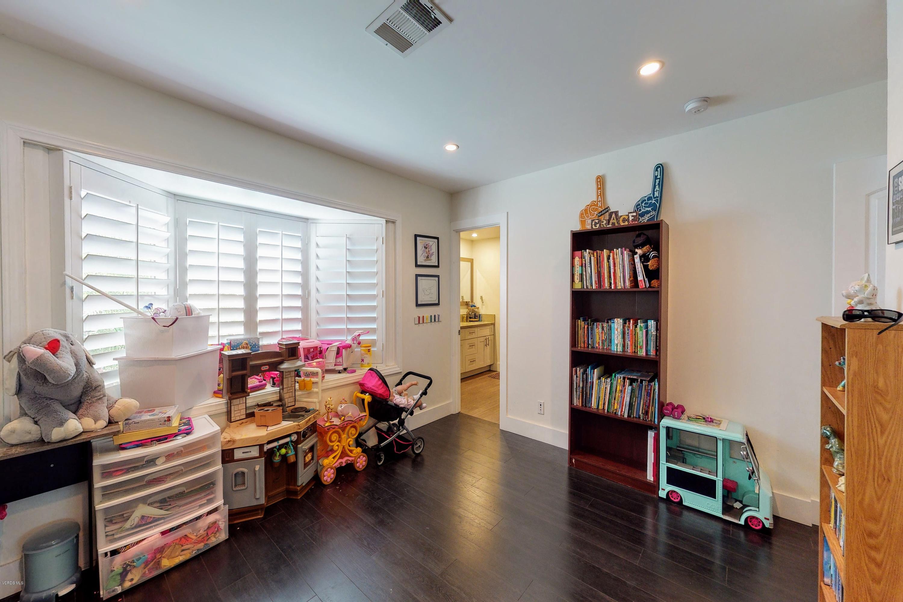 2298 Copley Street Simi Valley, CA 93063 - Photo 21 of 51 a living room with furniture and a book shelf