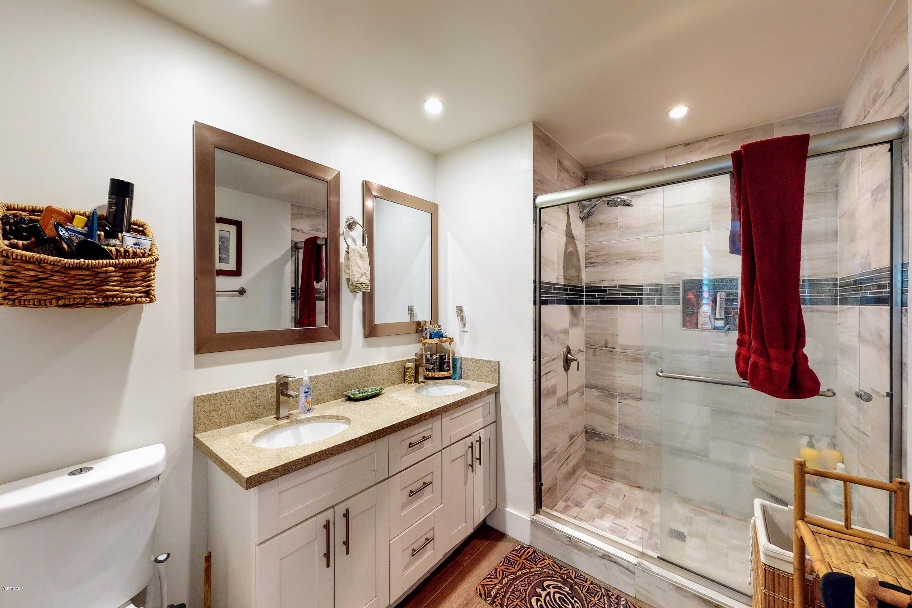 2298 Copley Street Simi Valley, CA 93063 - Photo 22 of 51 a bathroom with a granite countertop sink mirror and shower