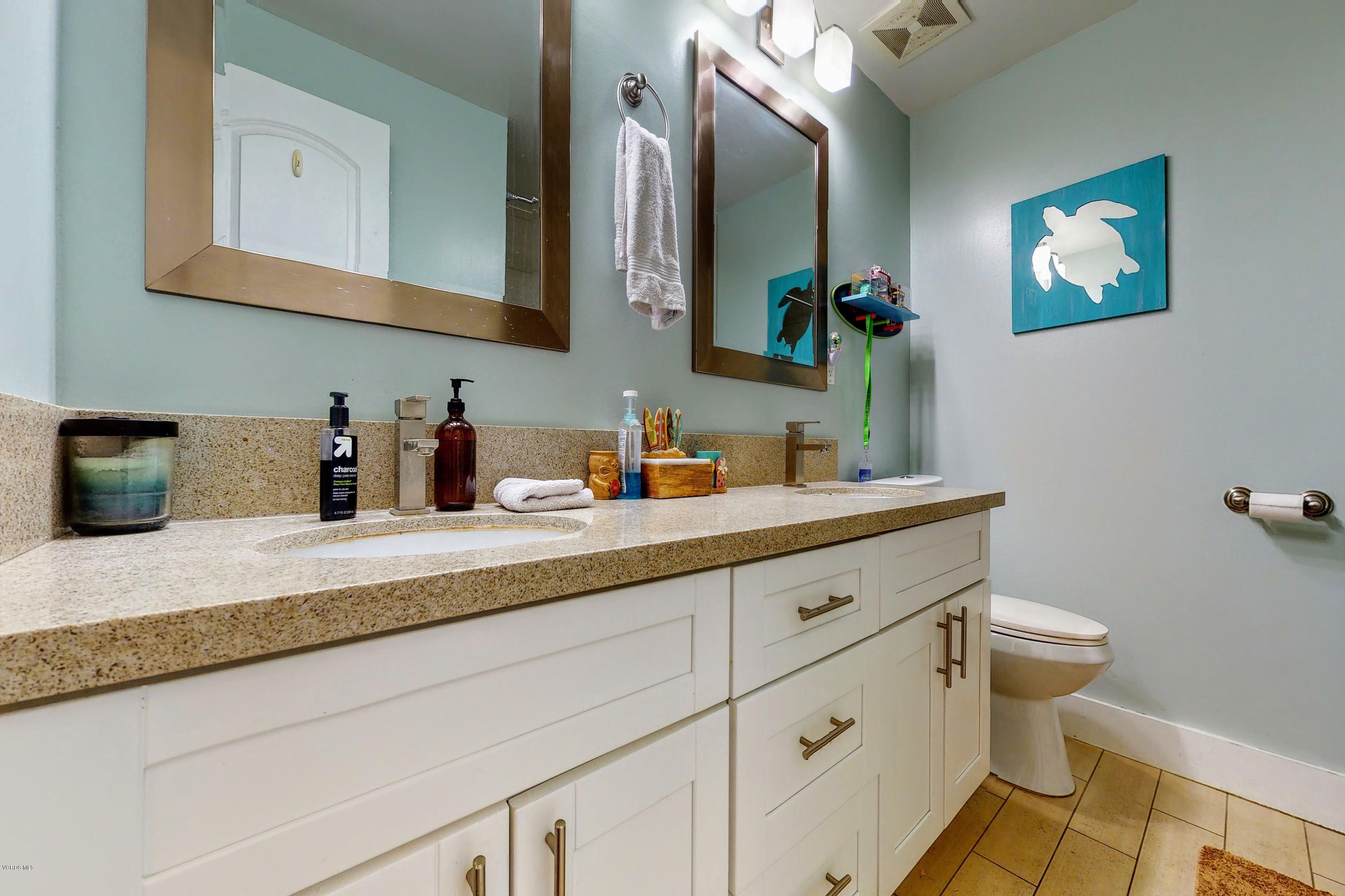 2298 Copley Street Simi Valley, CA 93063 - Photo 23 of 51 a bathroom with a sink a mirror and a toilet