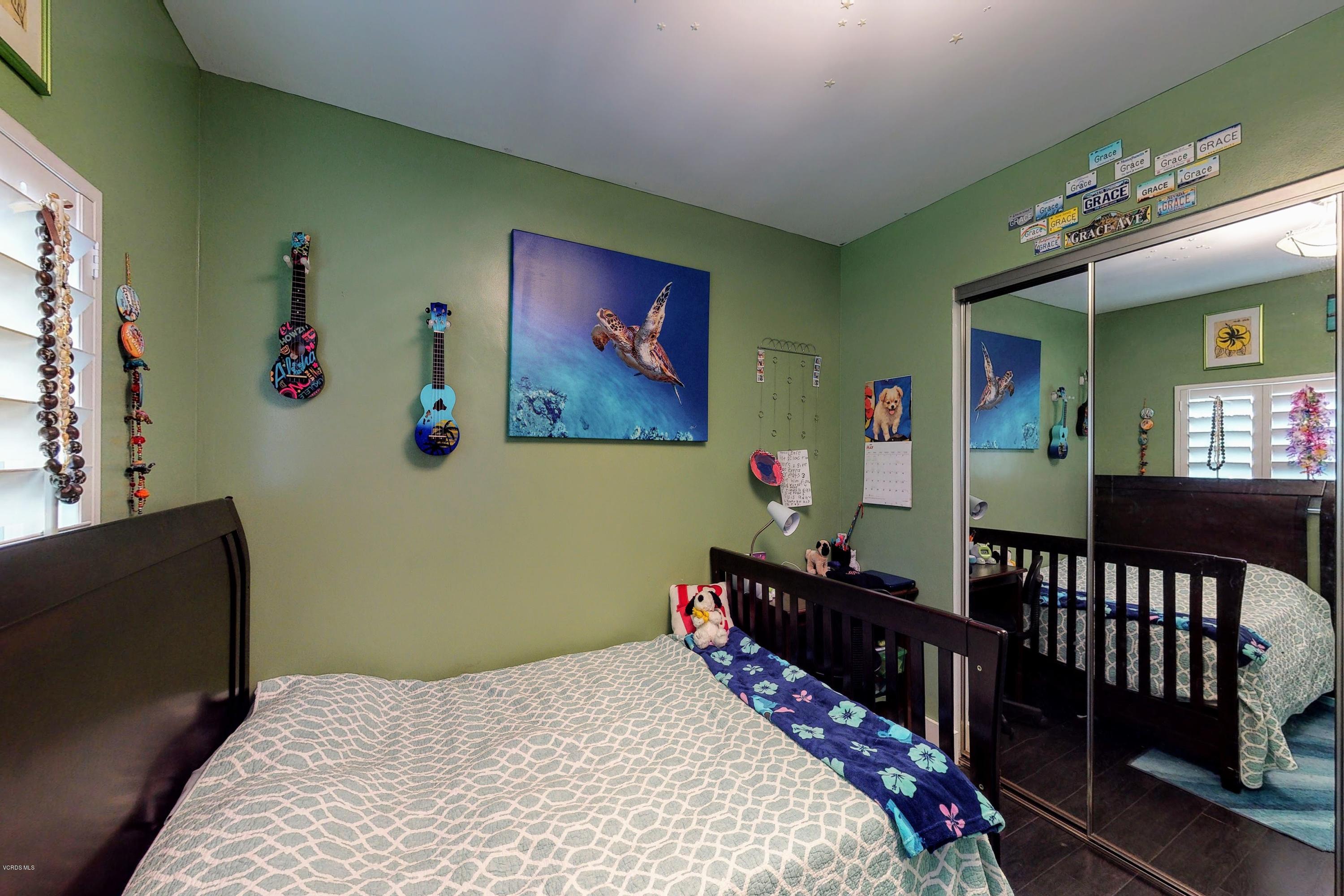 2298 Copley Street Simi Valley, CA 93063 - Photo 27 of 51 a bedroom with bed and paintings on the wall