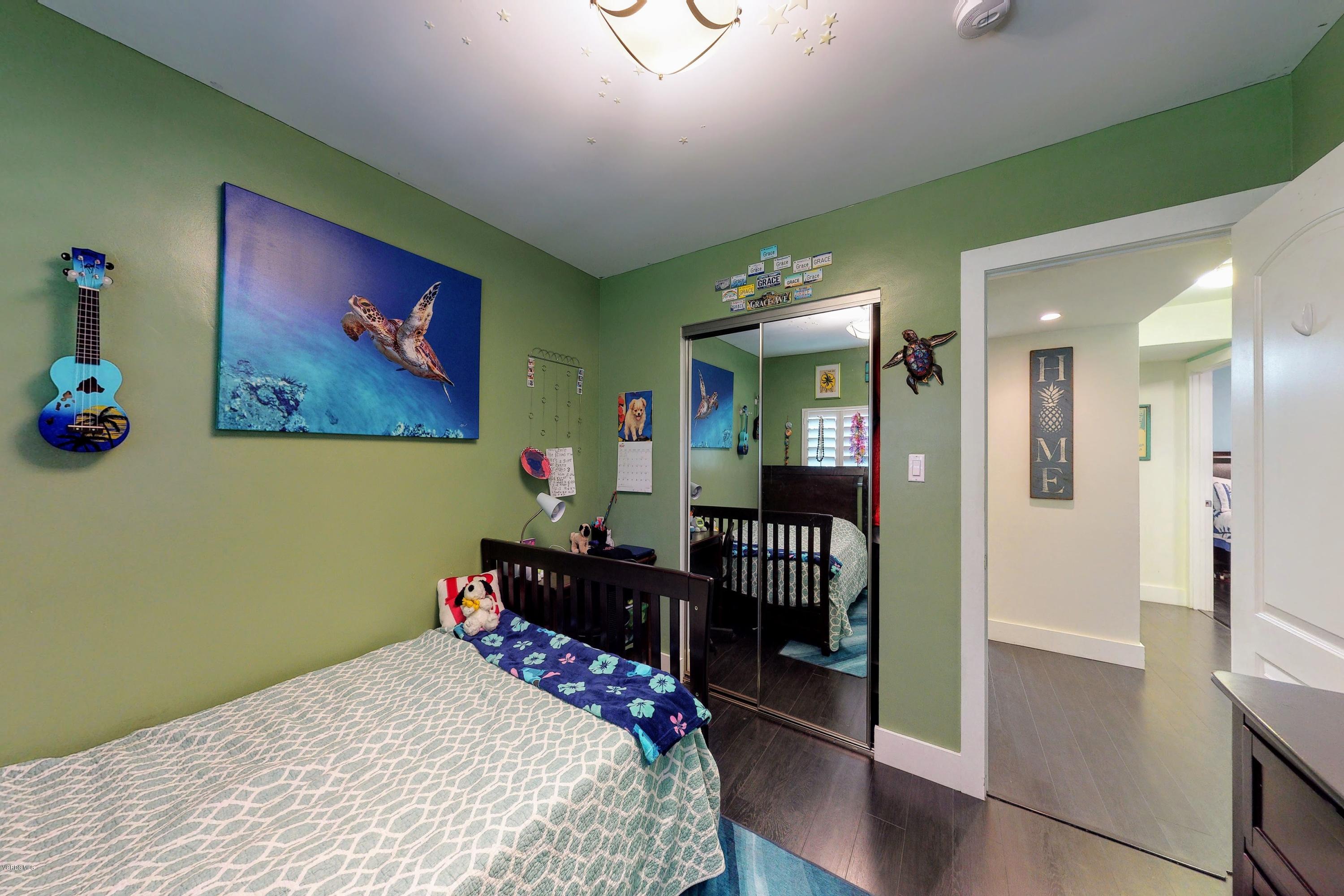 2298 Copley Street Simi Valley, CA 93063 - Photo 28 of 51 a bedroom with a bed and a chandelier
