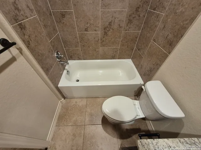 a view of backyard with wooden fence