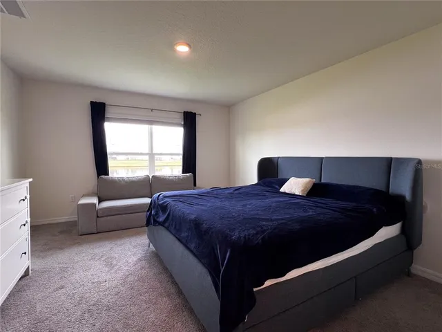 a bedroom with a bed and window