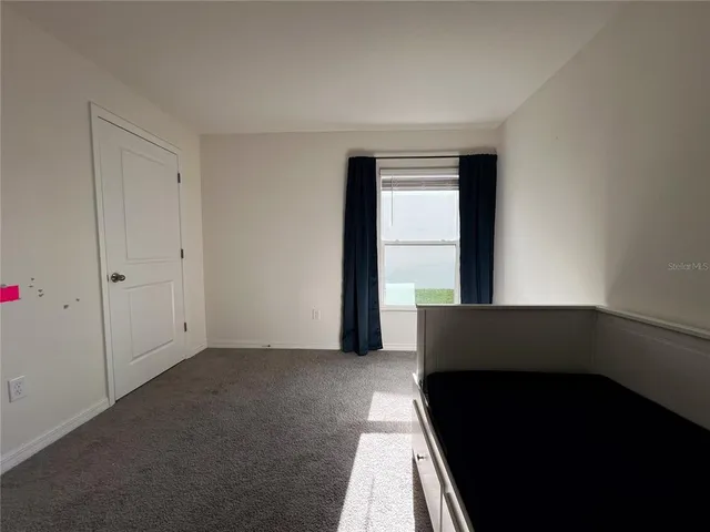 a living room with a black white wall and a black gate