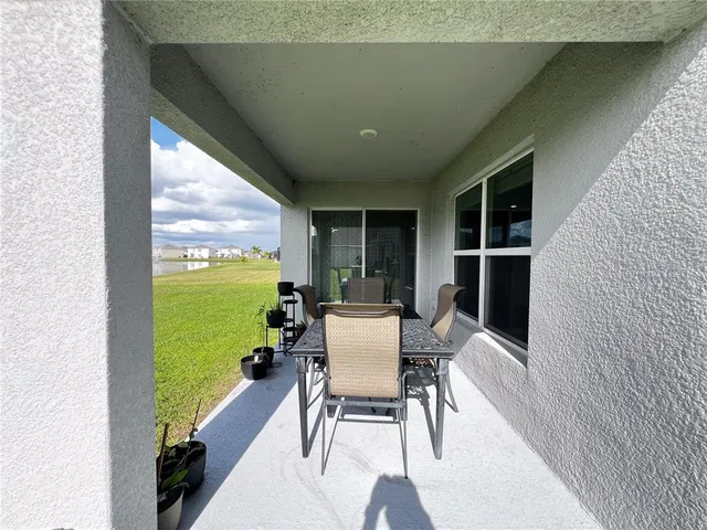 a dining room with furniture and floor to ceiling window