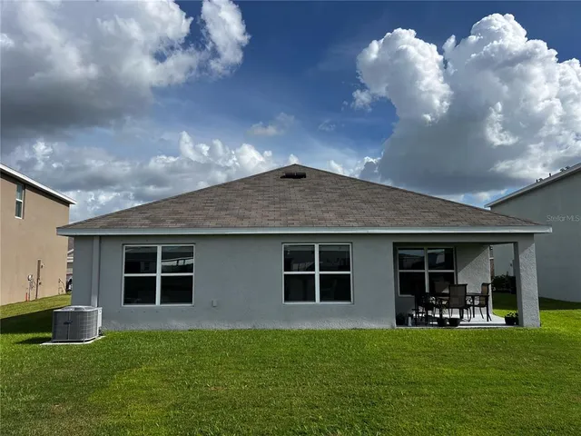 a front view of a house with a garden and yard