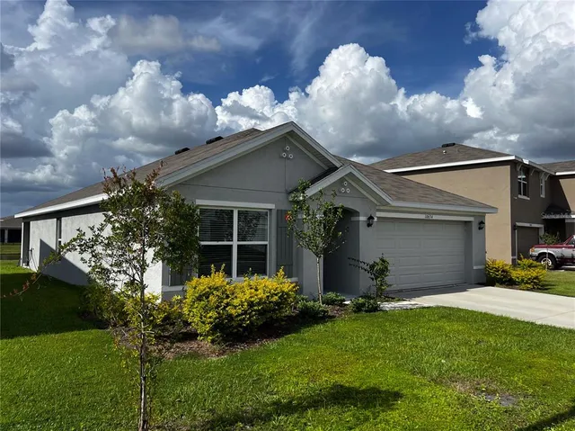 a front view of house with a garden