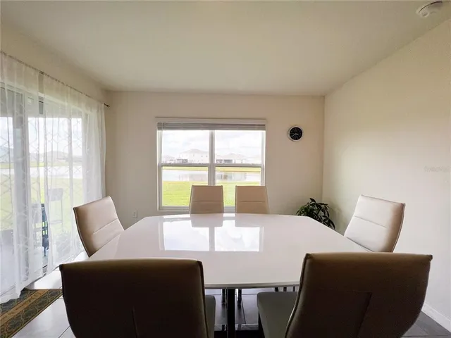 a view of a dining room with furniture window and outside view