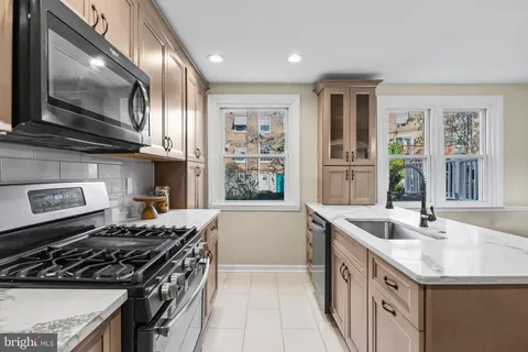 a kitchen that has a sink and a stove