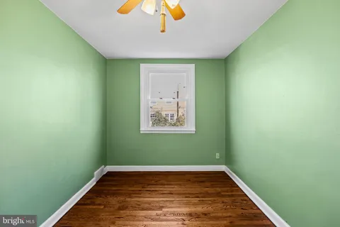 a view of a room with wooden floor and a window