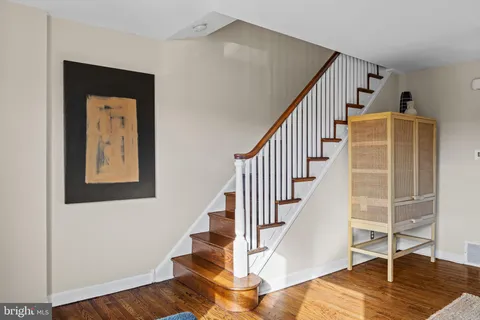 a view of entryway and hall with wooden floor