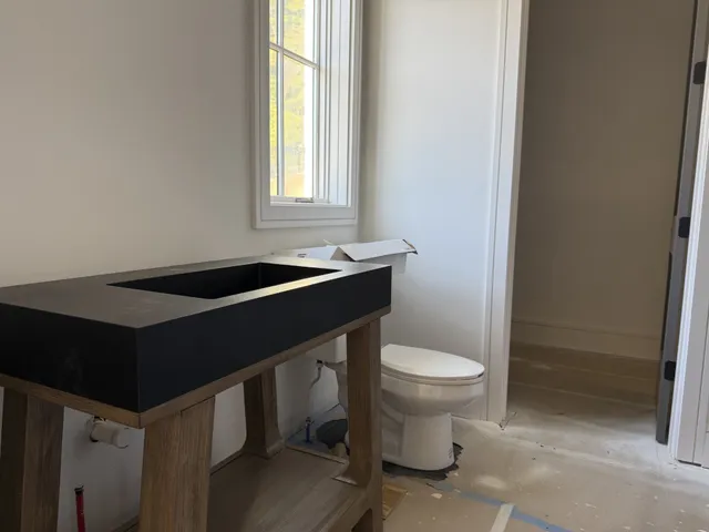 a view of staircase with lots of frames on wall and stairs