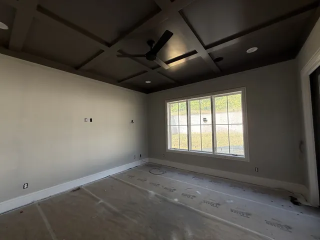 a kitchen with granite countertop white cabinets and black appliances